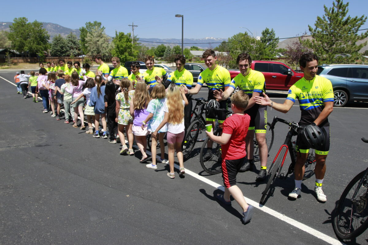 Journey of Hope cyclists posing as a group with their bikes.